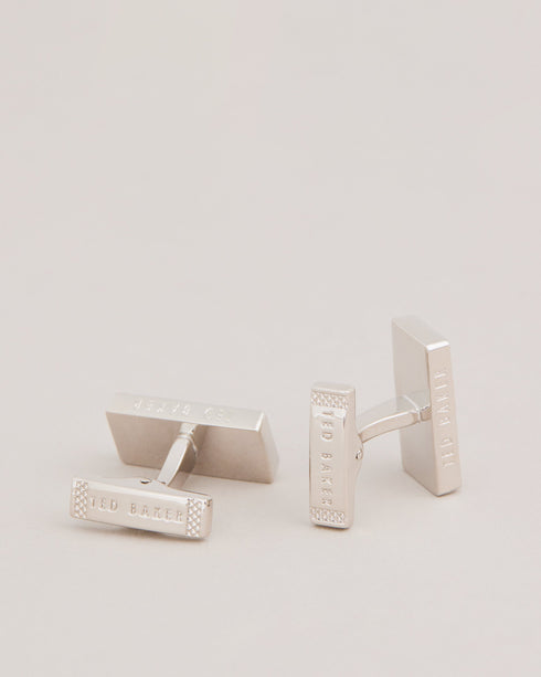 CHECKYU-Cufflinks-For the man who appreciates the finer things in life, CHECKYU are a must-have accessory. We've taken these cufflinks to the next level with our exclusive house check texture and sleek modern design. What more could he ask for? Cufflinks House check texture Metallic plating Ted Baker branded Comes in Ted Baker branded packaging- Ted Baker Romania